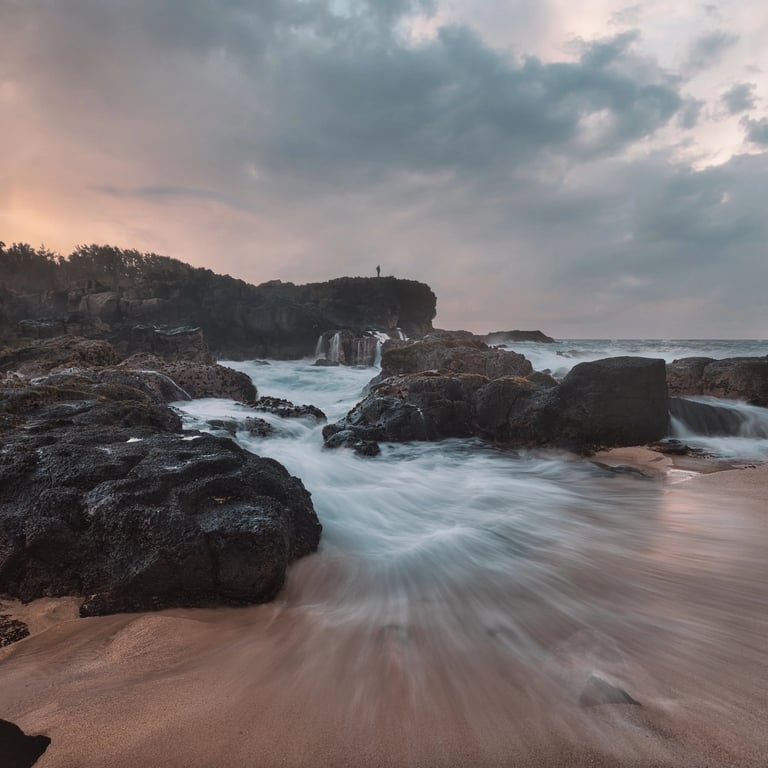 Waves flowing over rocks on the dramatic coastline of Le Souffleur at sunset in Mauritius