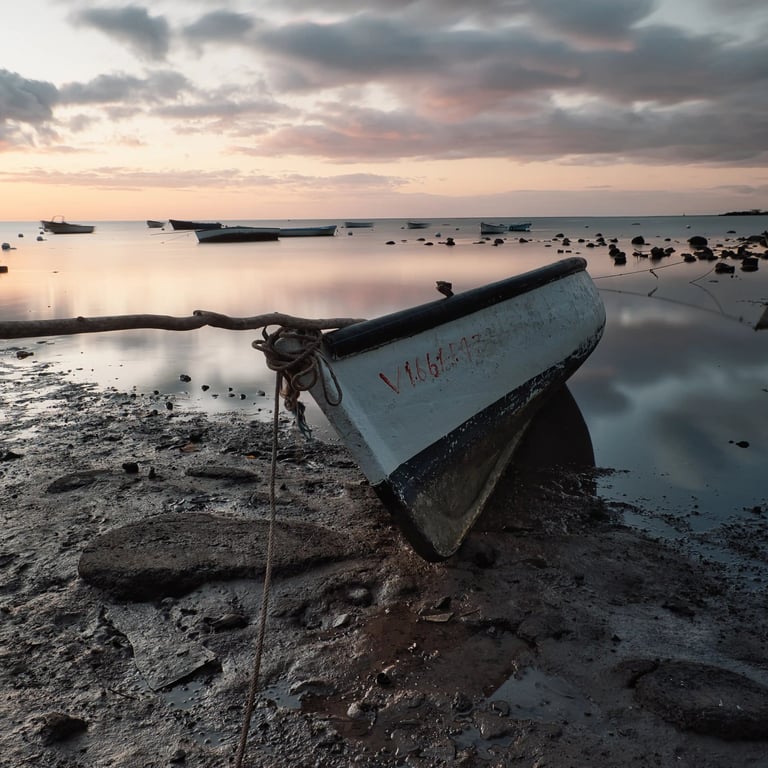 Fishing boats at low tide during sunset at Petite Case Noyale in Mauritius.