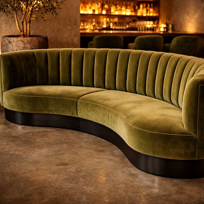 Custom curved olive green velvet banquette with channel tufting and sculptural base by Solo Home Decor
