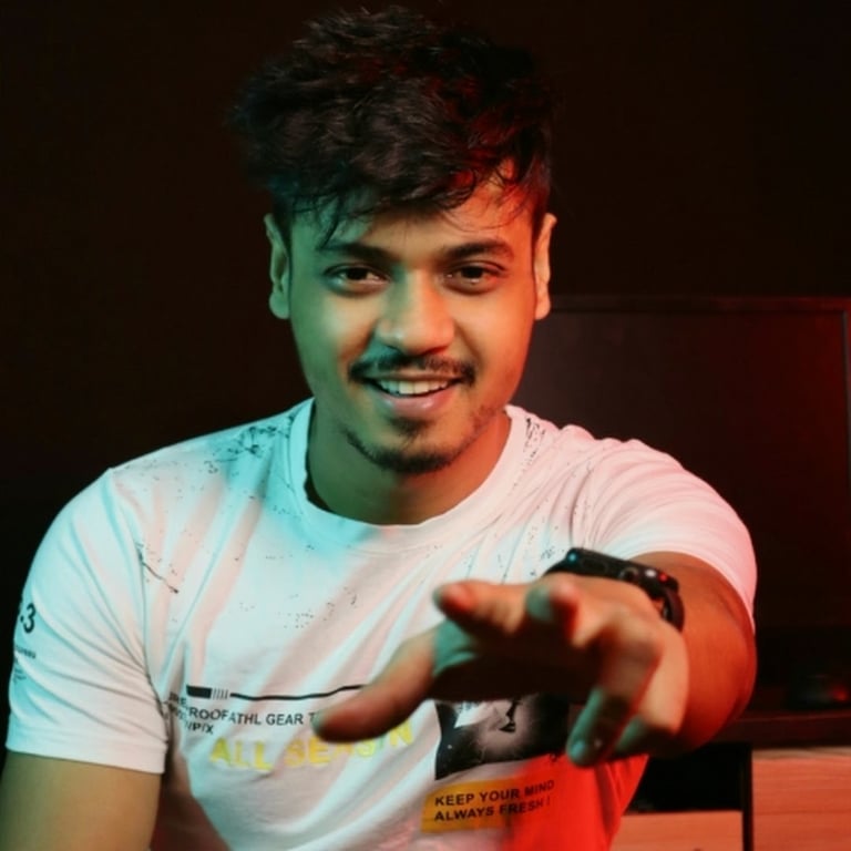 a man in a white shirt is holding a remote control