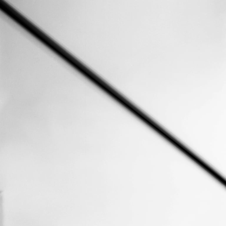 A monochrome image of a street sign, devoid of color, captured in black and white.