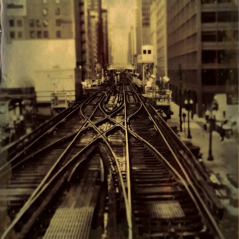 A train track with a city in the background, captured in a tintype filter in Chicago