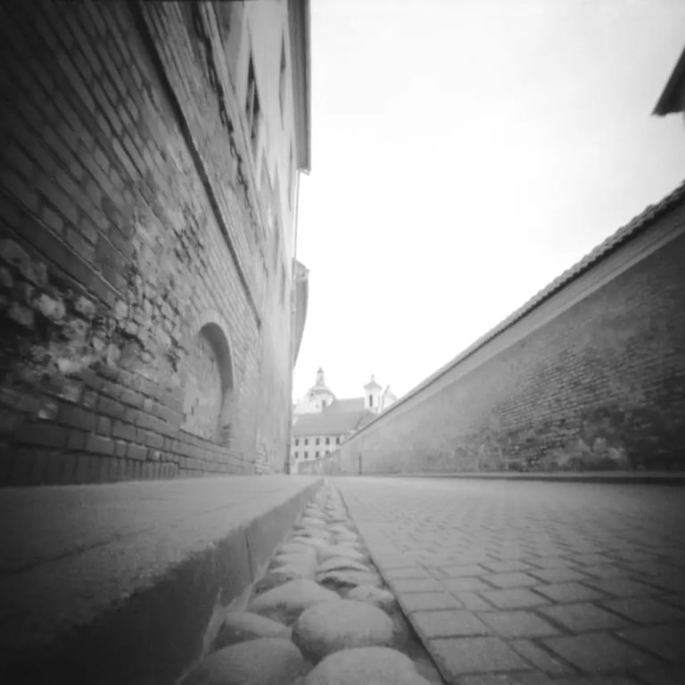 A narrow alley in Vilnius Old Town, captured in black and white