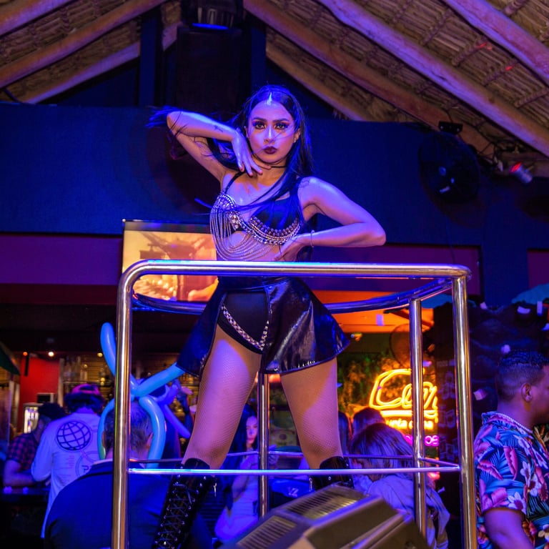 a woman in a black leather outfit standing on a metal barcocobongo punta cana