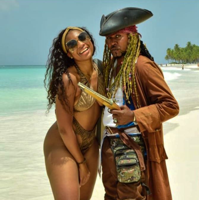 a man and woman in pirate costume on a beach saona island and pirata