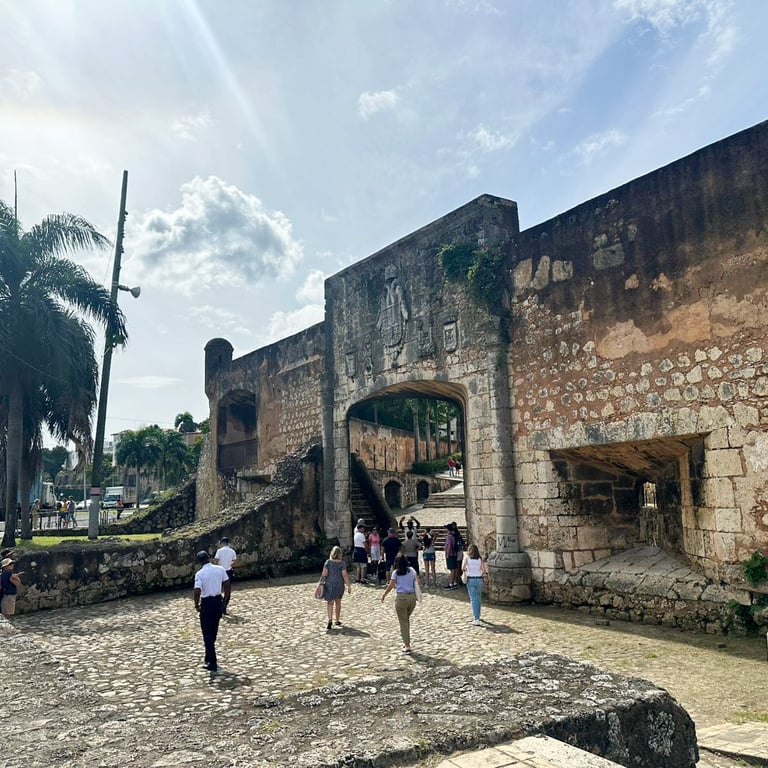 a group of people walking around a stone wall santo domingo punta cana