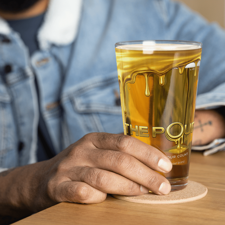 The Pour Shop branded pint glass shown in packaging box with materials demonstrating hospitality merchandise presentation