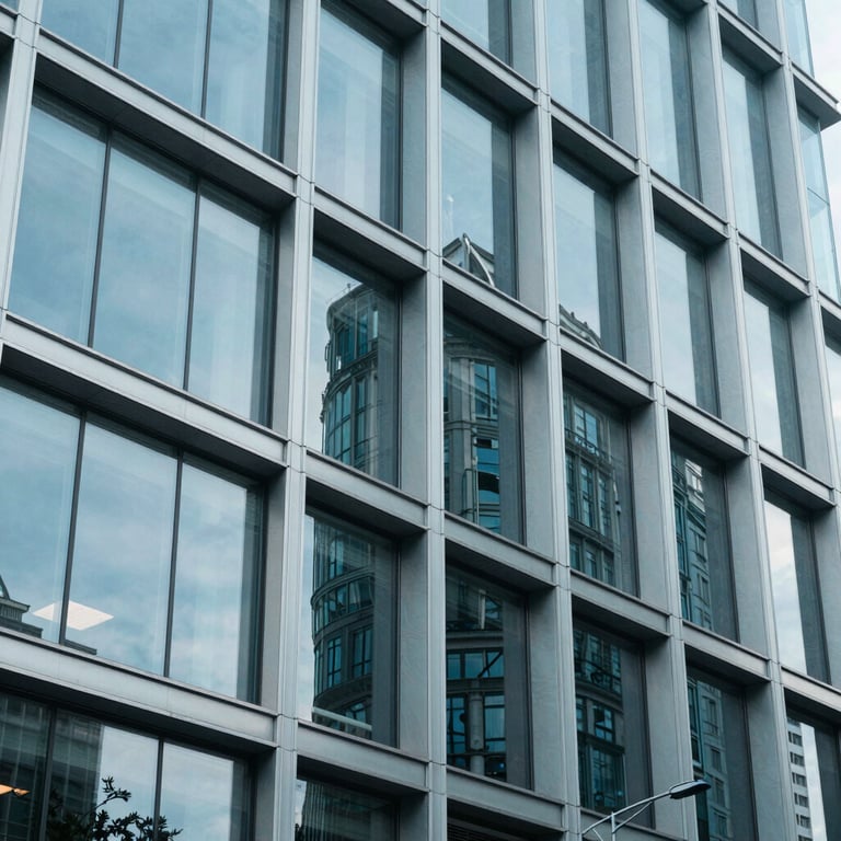 Modern architectural details of a legal center, showing glass and steel in pale arctic blue tones.