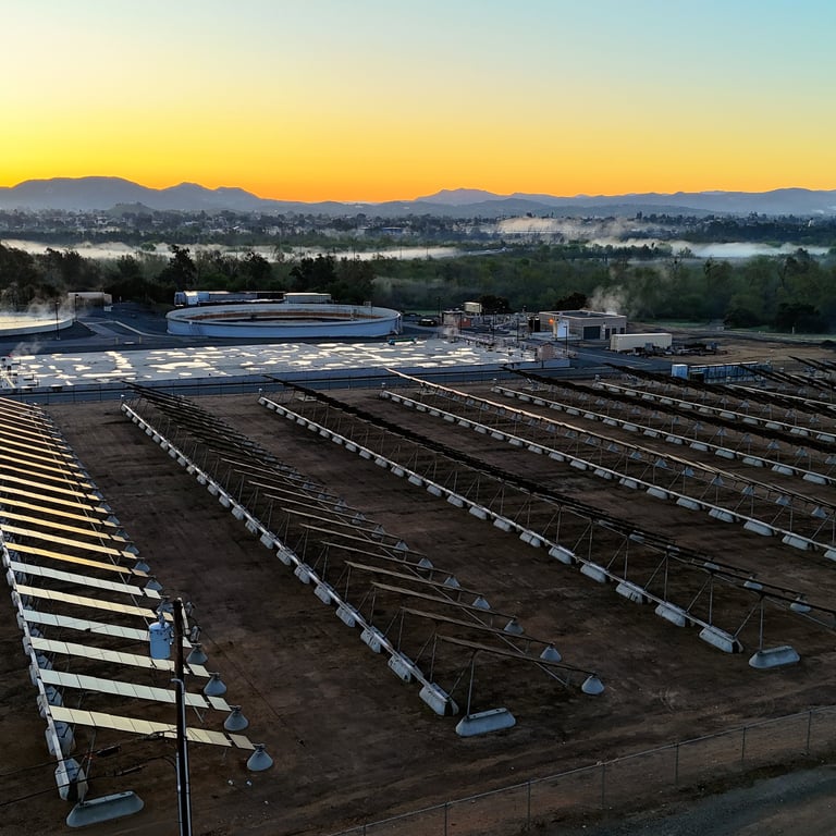 Aerial sunset view of large industrial facility with solar arrays and infrastructure in Corona, CA