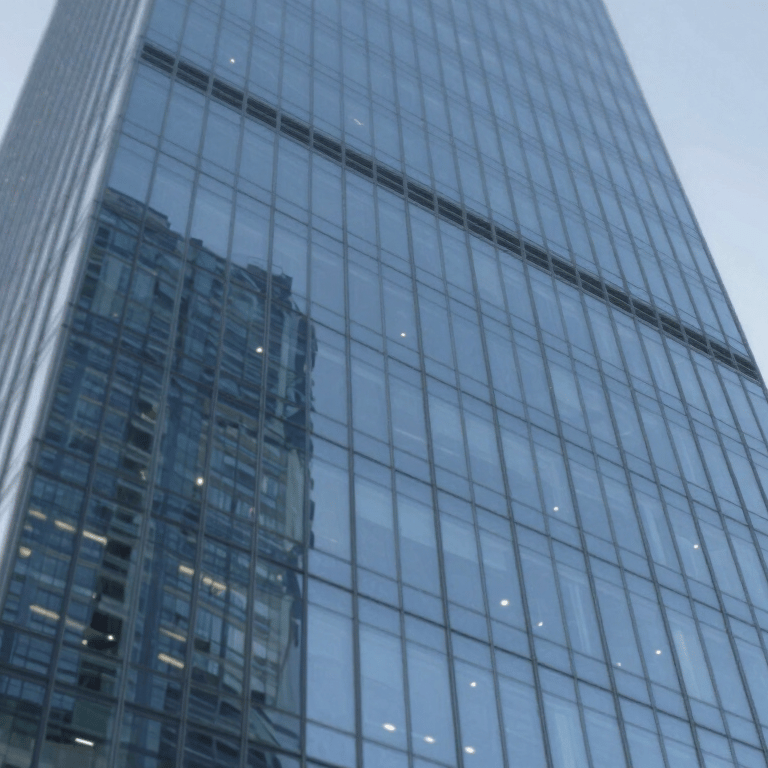 A minimalist glass staircase with invisible fixings in a bright luxury hallway, featuring #F7F9FB lighting.