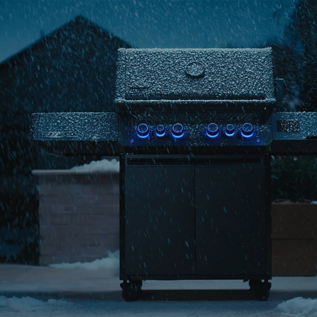 Close up of a Napoleon grill covered in water droplets to show weather resistance