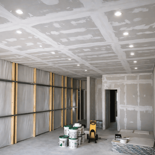 Drywall installation and taping in a home renovation project.
