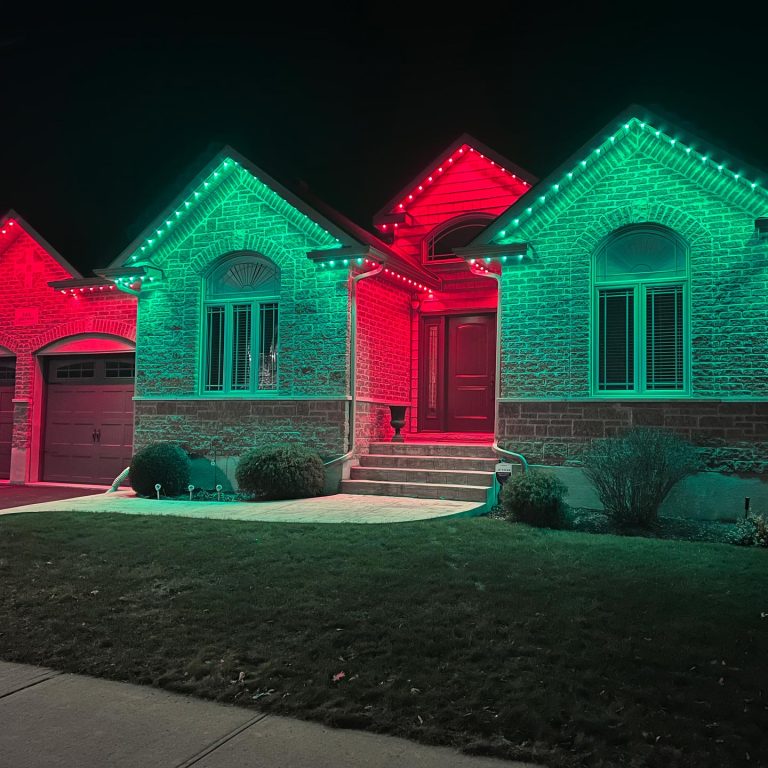 Bright LED outdoor lights decorating the roofline and windows of a house.