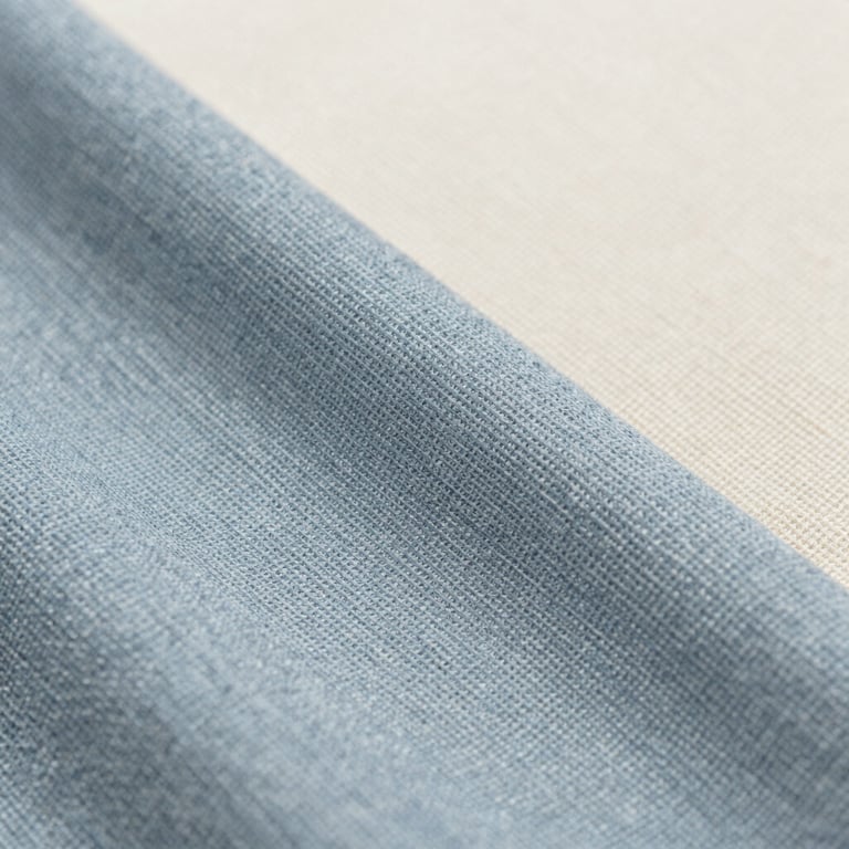 Close-up of high-quality textile textures and fine weaves in muted blue and off-white colors.