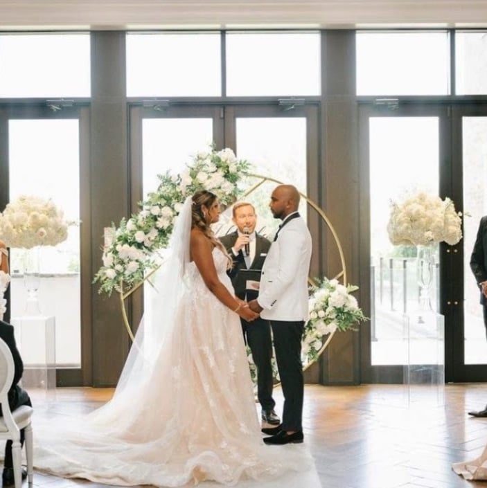 a bride and groom standing in front of a wedding ceremony