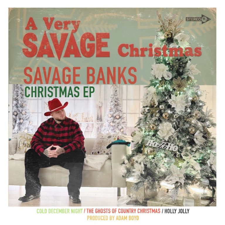Savage Banks sitting on a beige couch with a red cowboy hat and red flannel on, next to a Christmas tree with festive decor.