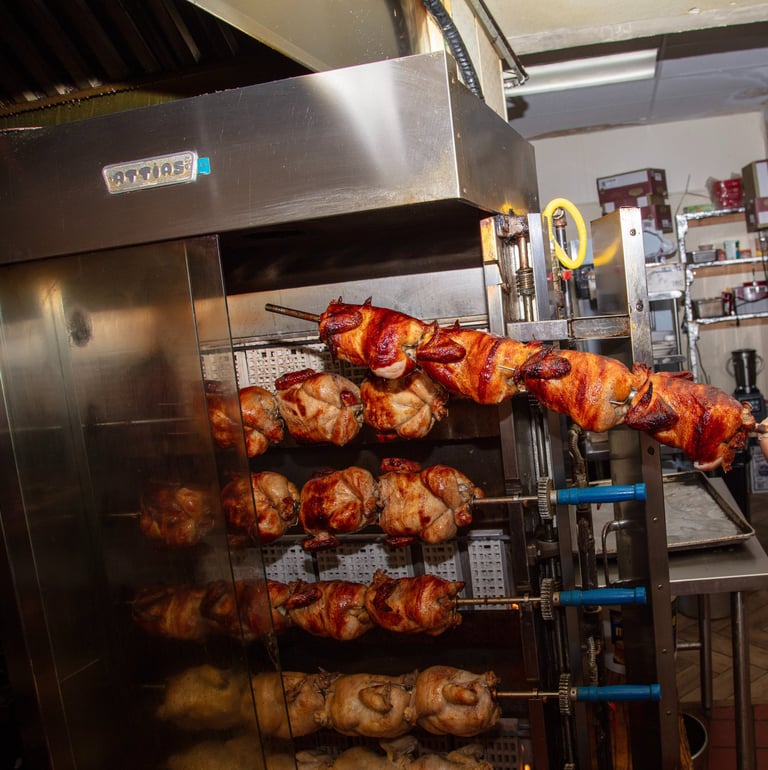 a man in a red shirt is holding a large rack with chicken