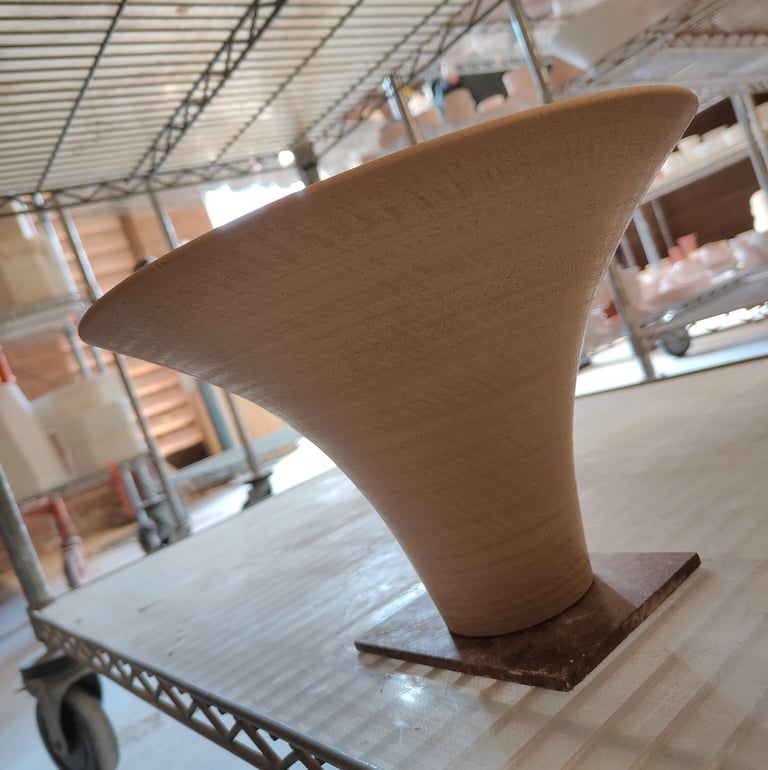 wheel-thrown, funnel-shaped, wormhole vase for ikebana, trimmed and ready for bisque fire