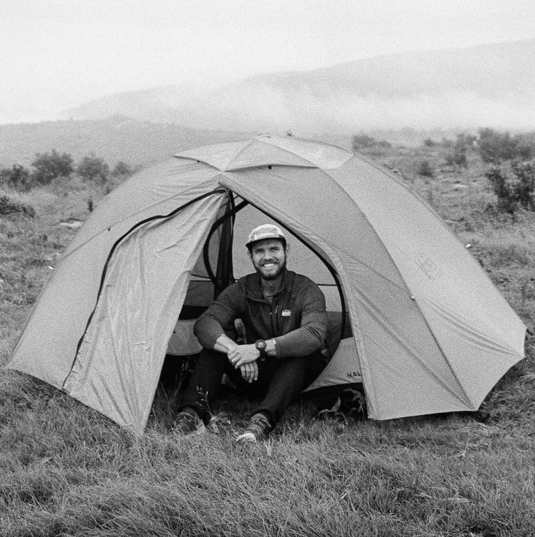 35mm film Nate Bowery sitting in tent while backpacking at Grayson Highlands State Park in Virgina