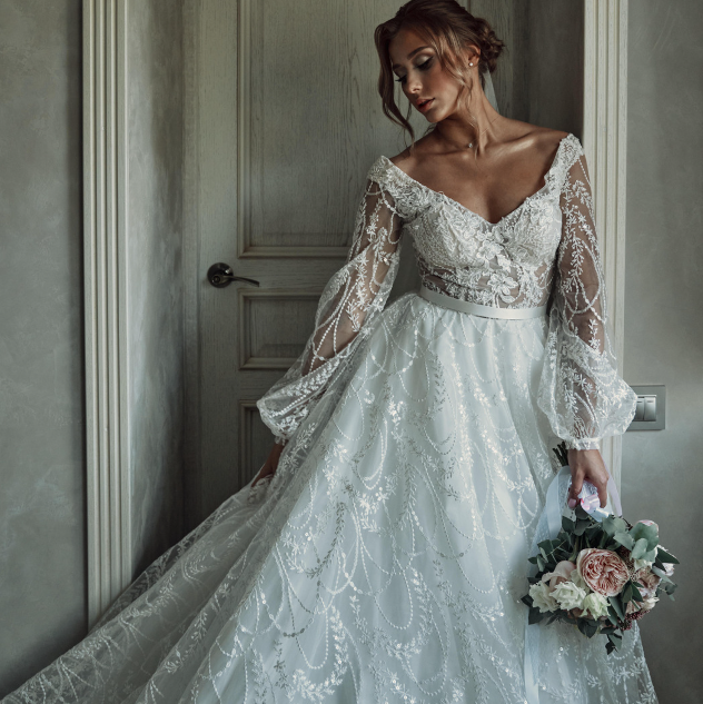a woman in a wedding dress with a bouquet in her hand