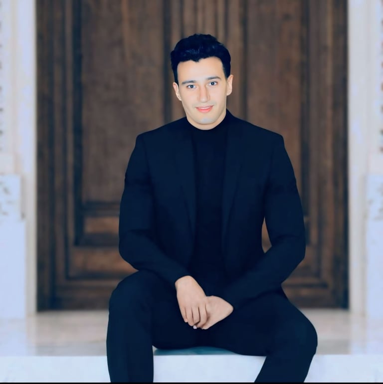a man in a suit and black shirt