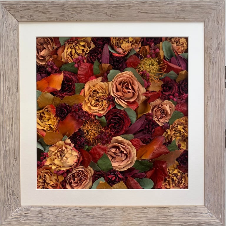 a flower wall style preserved wedding bouquet of autumnal colours in a frame