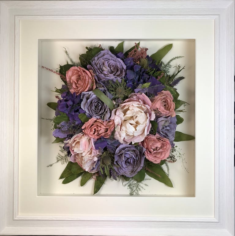 a photo of a Birdseye view preserved wedding bouquet in a frame