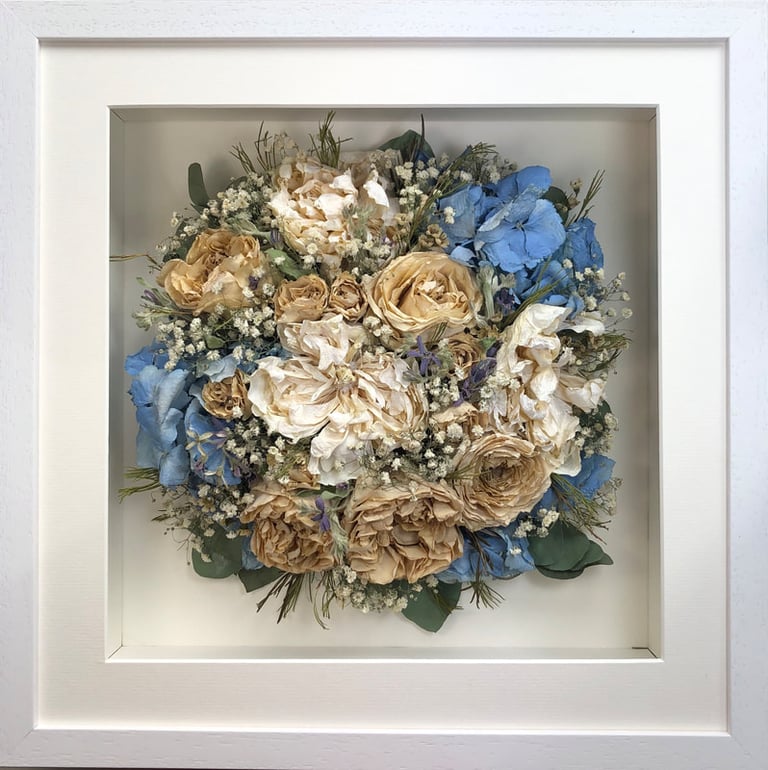 Birdseye view preserved wedding bouquet with soft ivory and blues in a frame