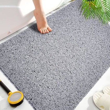 a person standing on a nonslip bathroom rug