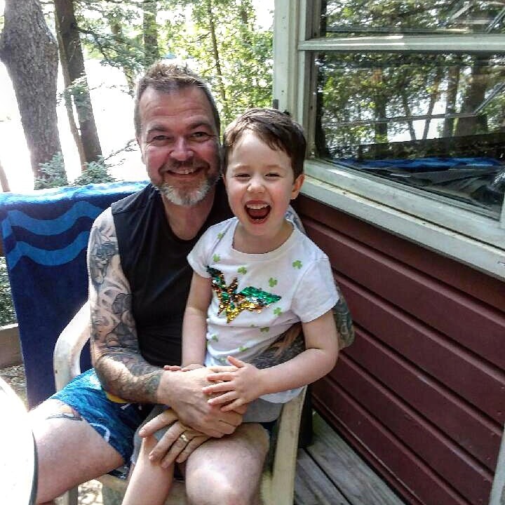 Sitting by a lake in Maine with my niece in August of 2019.