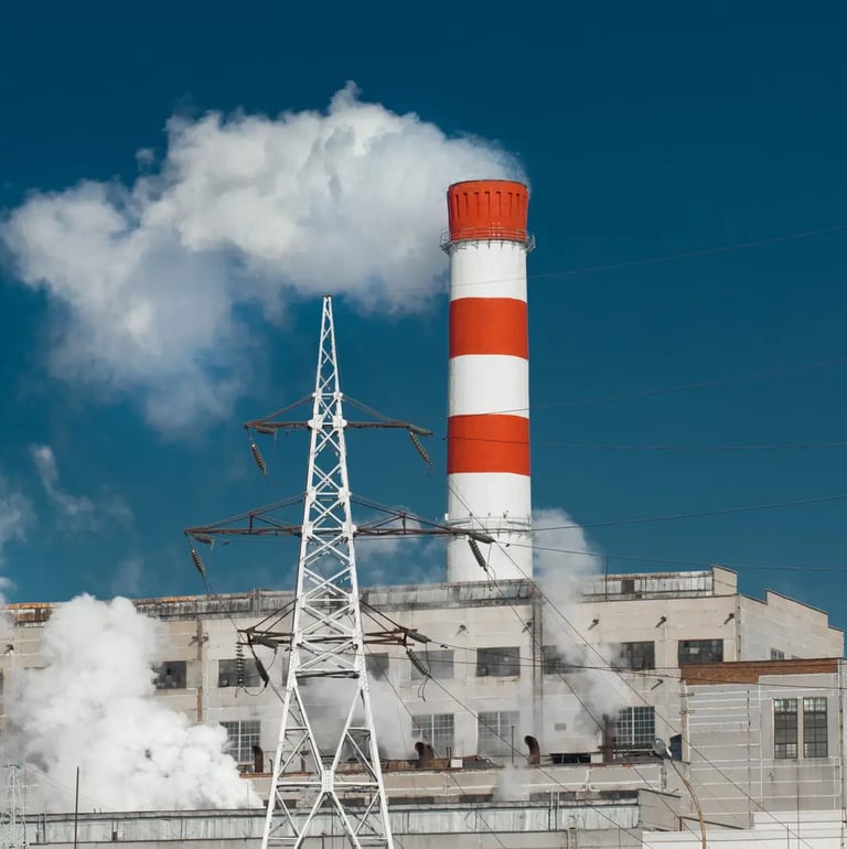 Smoke comming out of a red and white striped factory chimney