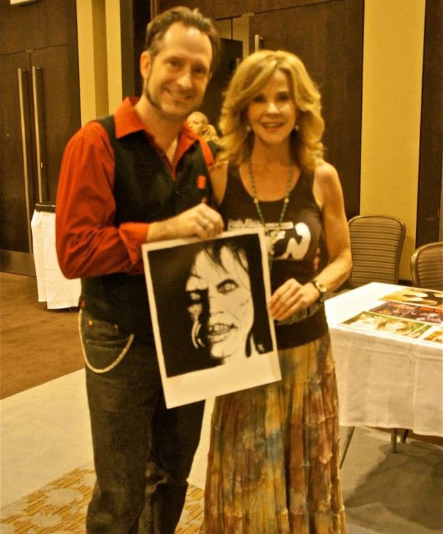 a man and woman holding a picture of a photo