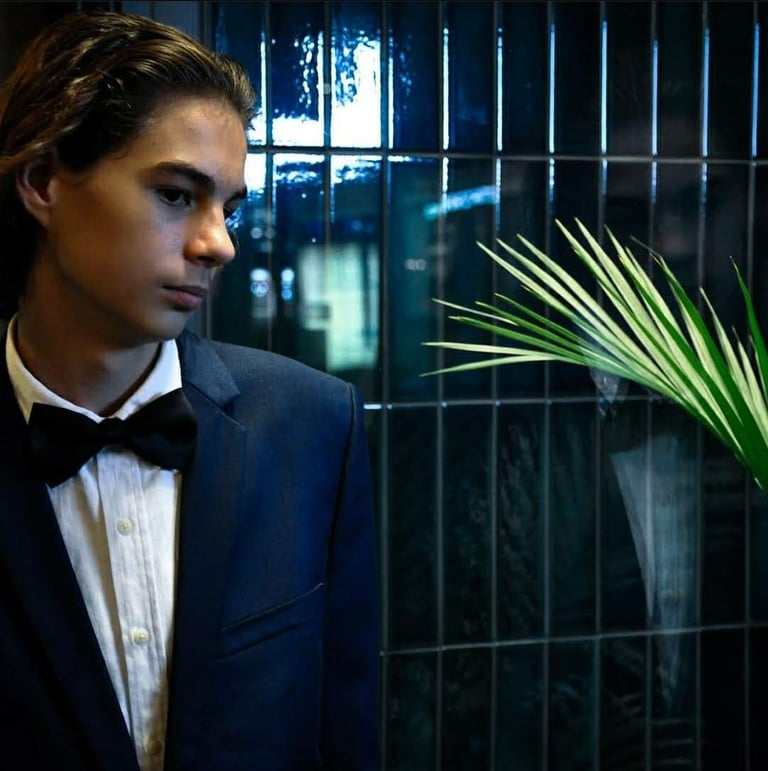 a man in a tuxedo suit and bow tie