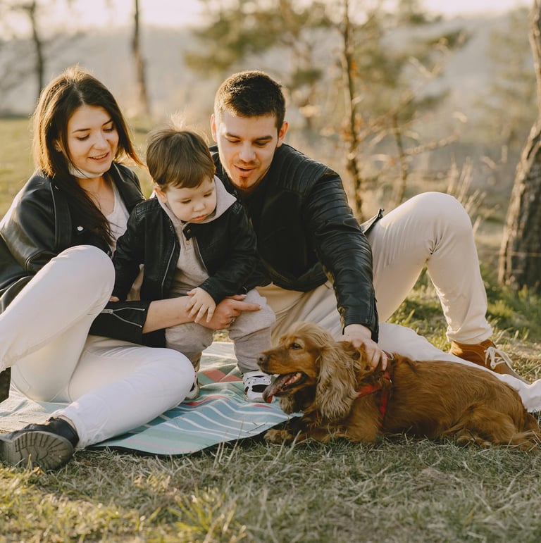 Young family sitting with their dog