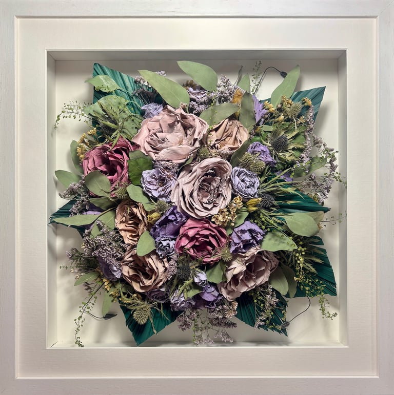 Birdseye view preserved wedding bouquet with teal fern branches in a frame