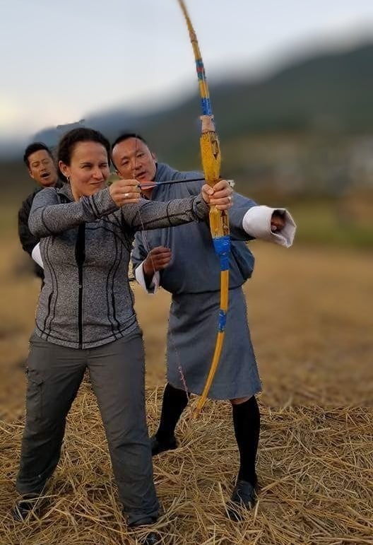 drukyul_delights_ceo_with_guest_experiencing_archery_session_in_punakha_bhutan