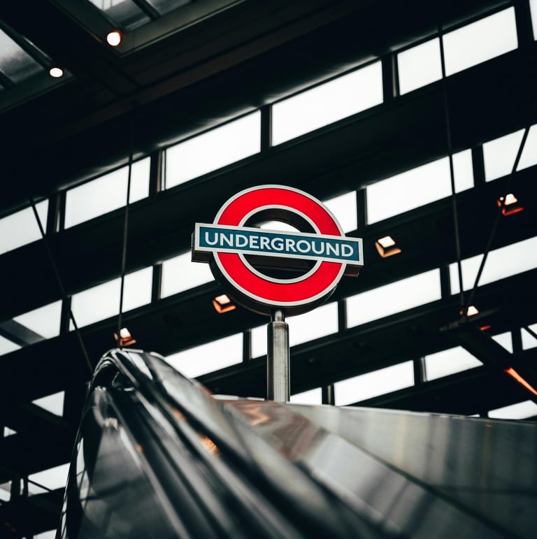London Underground roundel at the top of an escalator