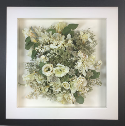 a photo of a Birdseye view preserved wedding bouquet in a frame