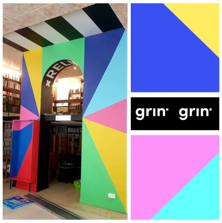 une fresque avec des triangles de couleurs vives et des inscriptions noir et blanches