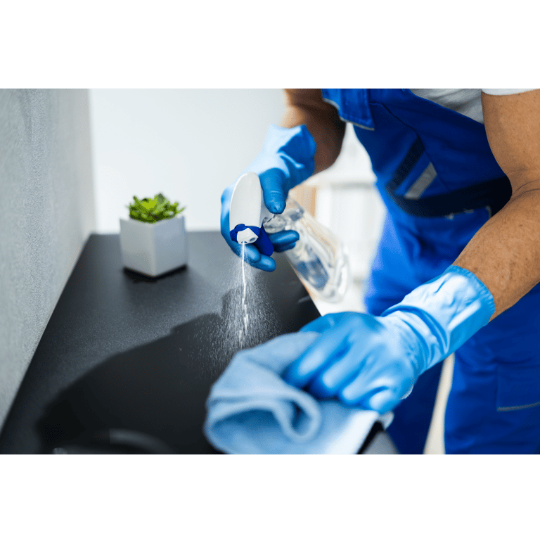 a man in blue gloves is cleaning a sink