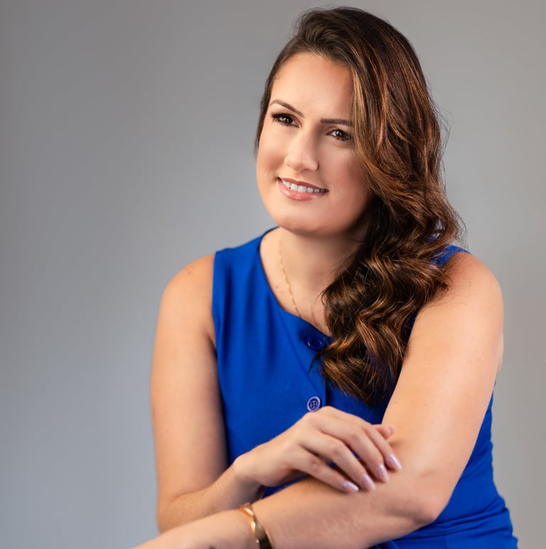 a woman in a blue dress sitting on a chair