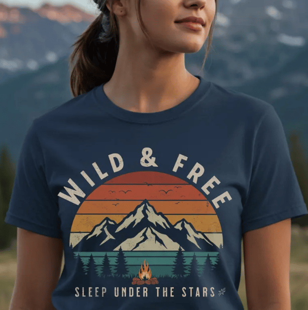 women wearing a nature explorer t-shirt with a mountain setting in the background