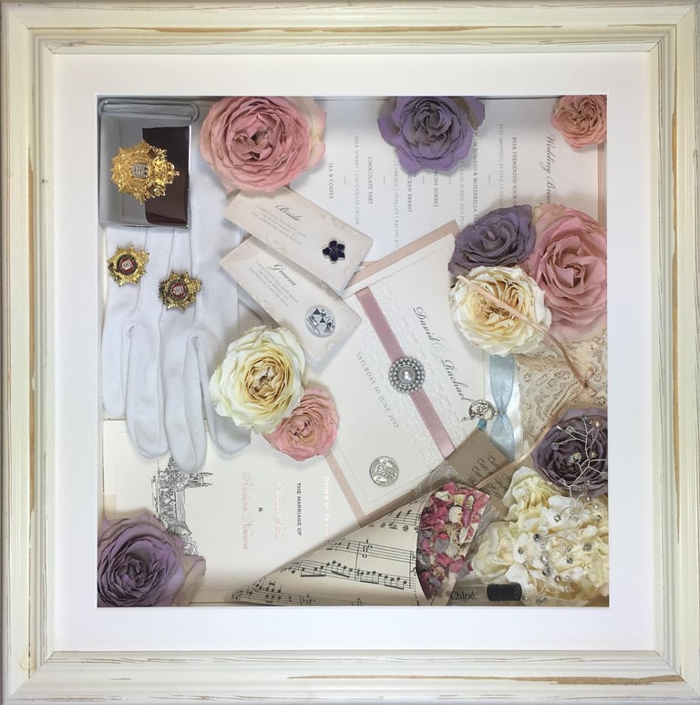 memory box full of preserved wedding flowers, gloves, invitations, music sheets and other keepsakes