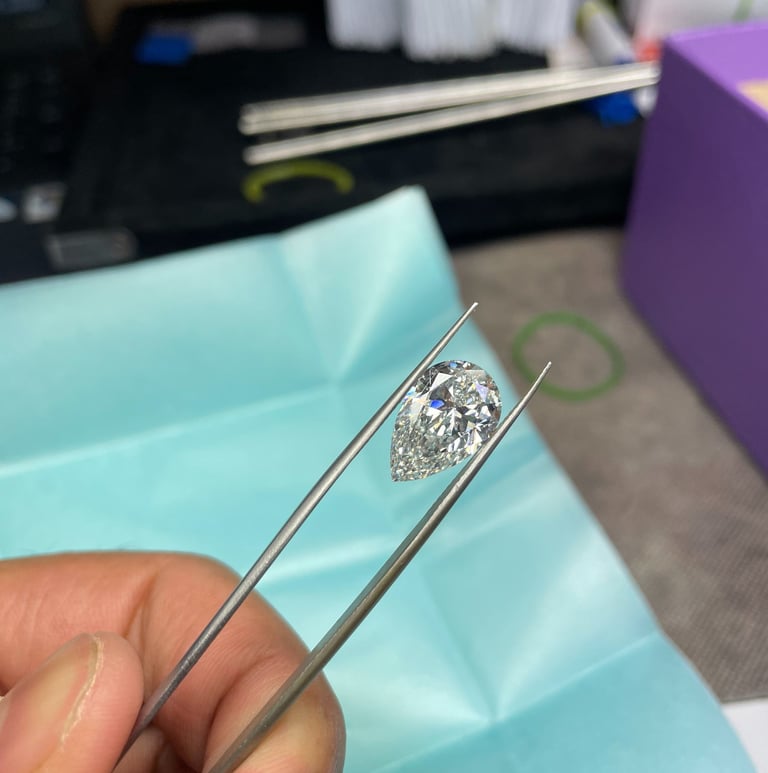 A person holding a polished lab grown diamond