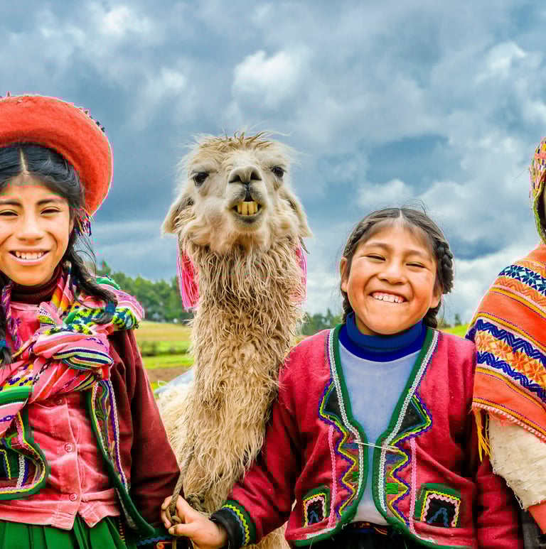 two happy kids from the Andes with a llama.  Dos ninos felices de los Andes con una llama