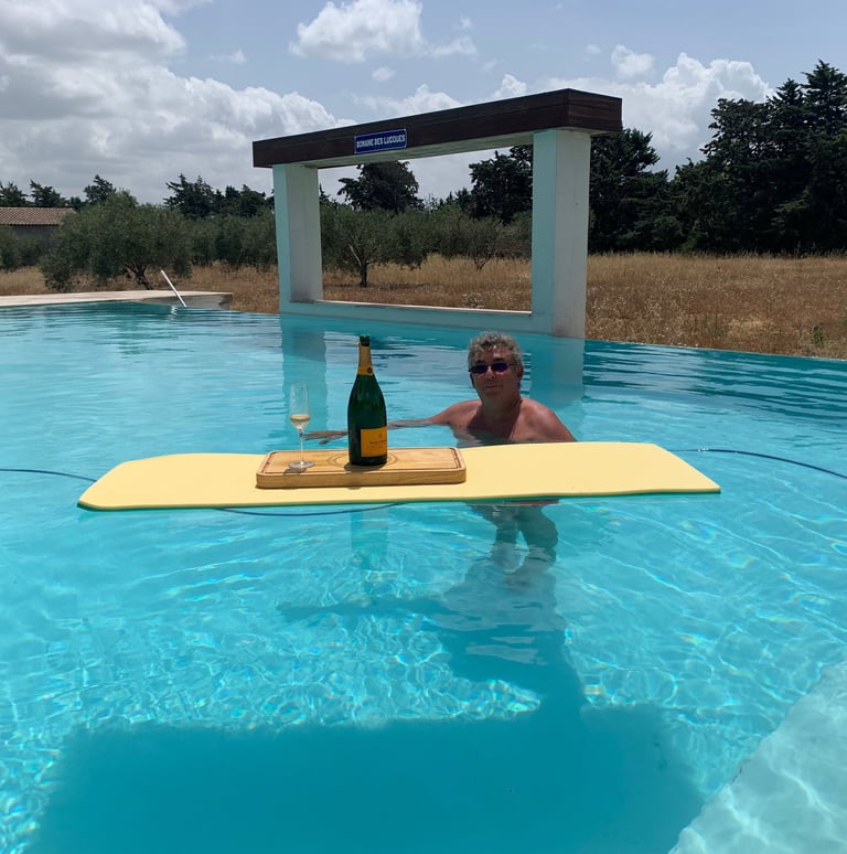 Guest enjoying the infinity swimming pool at Domaine Des Lucques