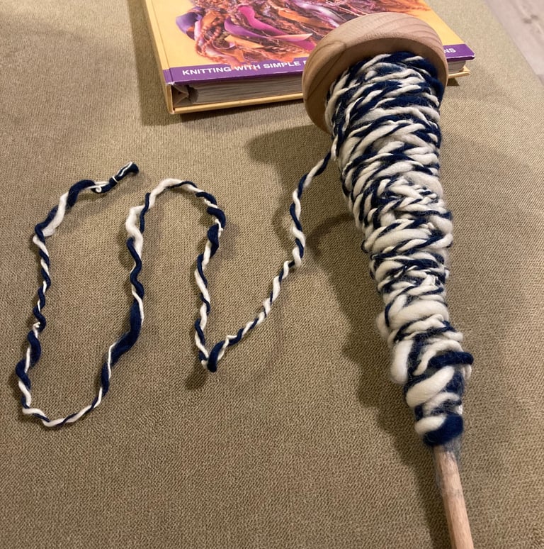 A beginner attempt at plying wool on an Ashford student spindle