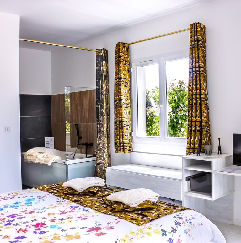 Bedroom with bathroom and toilet, television, air conditioner and pool view at Domaine Des Lucques