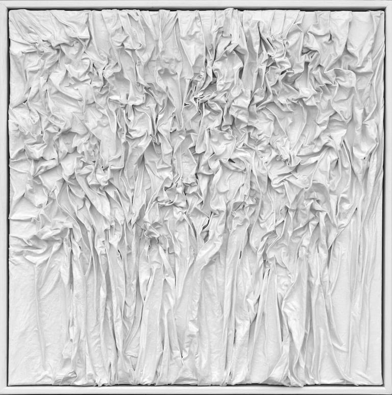 Textured white monochromatic 3D wall art with draped and crumpled fabric patterns.