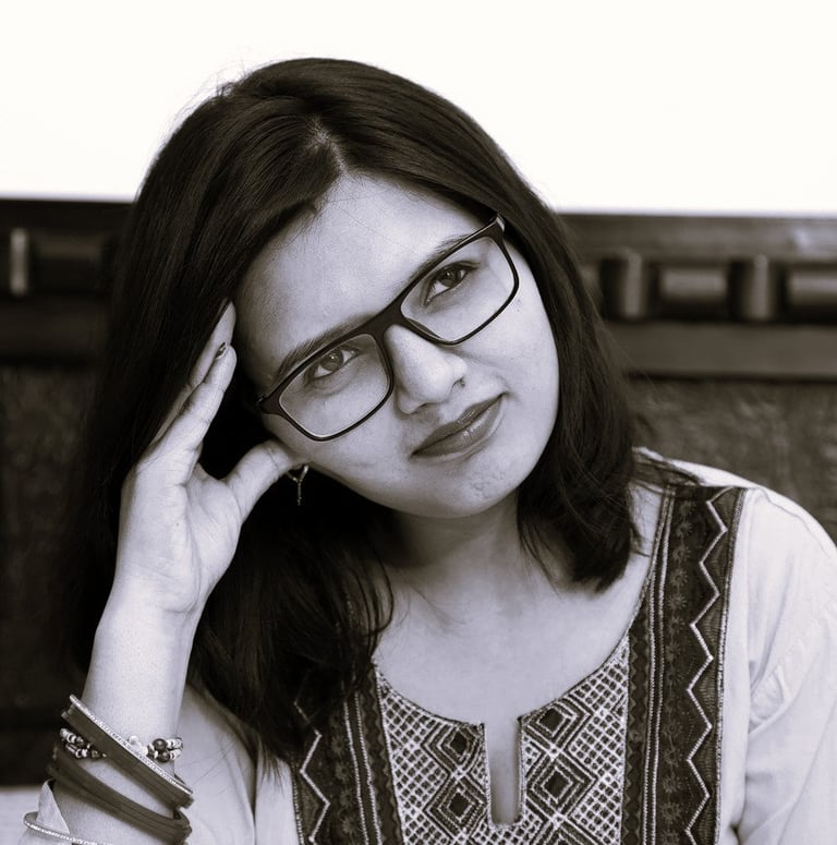 a woman in glasses gazing to the distance